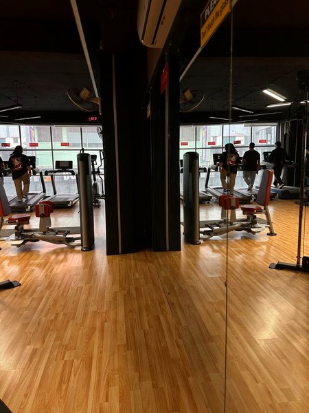 Mirrors and machines on wood flooring