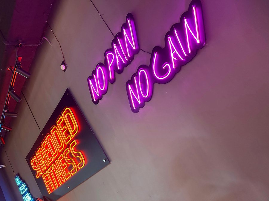 Neon signage wall inside Shredded Fitness