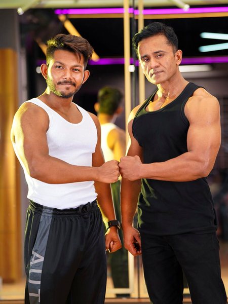 Two training partners fist-bumping in the gym